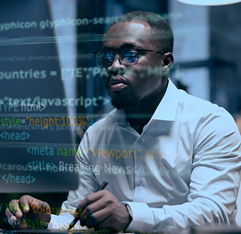 a man sitting in front of a laptop computer